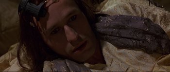 Movie still from “Strange Days” (1995), directed by Kathryn Bigelow – A person laying on a bed; Close Up shot, High angle