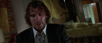 Movie still from “Strange Days” (1995), directed by Kathryn Bigelow – A person wearing a suit and tie; Close Up shot, Low angle