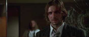 Movie still from “Strange Days” (1995), directed by Kathryn Bigelow – A person wearing a suit and tie; Close Up shot, Low angle