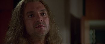 Movie still from “Strange Days” (1995), directed by Kathryn Bigelow – A person with long blonde hair; Close Up shot, Low angle