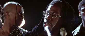 Movie still from “Strange Days” (1995), directed by Kathryn Bigelow – A person wearing glasses; Close Up shot, Low angle