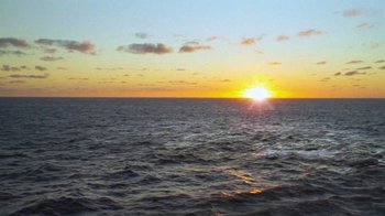 Movie still from “Strawberry Mansion” (2021), directed by Kentucker Audley – The sun is setting over the ocean as seen from a boat; Extreme Wide shot, High angle