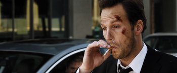 Movie still from “Stretch” (2014), directed by Joe Carnahan – A person smoking a cell phone; Close Up shot, Over the shoulder angle