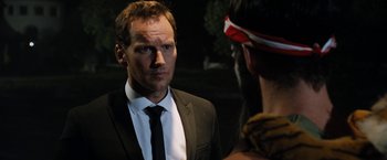 Movie still from “Stretch” (2014), directed by Joe Carnahan – A man in a suit and tie talking to another man; Close Up shot, Over the shoulder angle