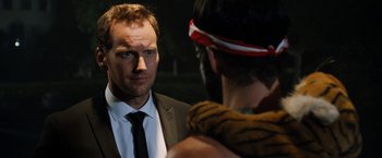 Movie still from “Stretch” (2014), directed by Joe Carnahan – A man in a suit and tie talking to another man; Close Up shot, Over the shoulder angle