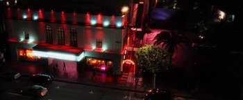 Movie still from “Stretch” (2014), directed by Joe Carnahan – An aerial view of a building at night with red lights; Extreme Wide shot, High angle