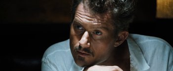 Movie still from “Stretch” (2014), directed by Joe Carnahan – A person wearing a white shirt; Close Up shot, High angle