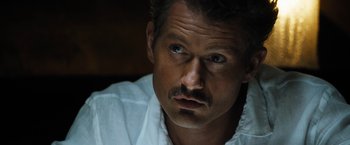Movie still from “Stretch” (2014), directed by Joe Carnahan – A person wearing a white shirt; Close Up shot, High angle