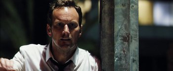 Movie still from “Stretch” (2014), directed by Joe Carnahan – A person wearing a shirt and tie; Close Up shot, Low angle