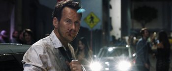 Movie still from “Stretch” (2014), directed by Joe Carnahan – A person holding a flashlight; Close Up shot, Over the shoulder angle