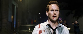 Movie still from “Stretch” (2014), directed by Joe Carnahan – A person with blood all over his face; Close Up shot, Over the shoulder angle