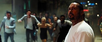 Movie still from “Stretch” (2014), directed by Joe Carnahan – A group of people are running in the street; Medium shot, Low angle