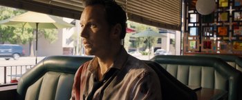 Movie still from “Stretch” (2014), directed by Joe Carnahan – A person sitting in a car; Close Up shot, Over the shoulder angle