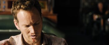 Movie still from “Stretch” (2014), directed by Joe Carnahan – A person sitting down with his eyes closed; Close Up shot, High angle