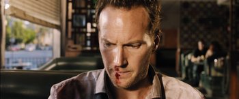 Movie still from “Stretch” (2014), directed by Joe Carnahan – A person with a cut face; Close Up shot, High angle