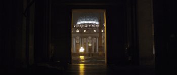 Movie still from “Suburra” (2015), directed by Stefano Sollima – A view of a building at night through a doorway; Extreme Wide shot, Low angle