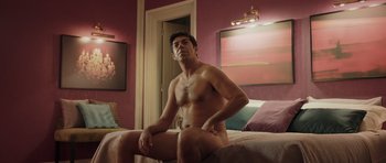 Movie still from “Suburra” (2015), directed by Stefano Sollima – A man sitting on a bed in a room; Medium shot, Over the shoulder angle