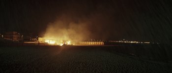 Movie still from “Suburra” (2015), directed by Stefano Sollima – A fire is burning in a field at night; Extreme Wide shot, High angle
