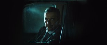 Movie still from “Suburra” (2015), directed by Stefano Sollima – A man sitting in the back seat of a car; Close Up shot, Low angle