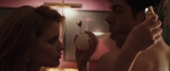 Movie still from “Suburra” (2015), directed by Stefano Sollima – A man and a woman are drinking from a glass; Close Up shot, Over the shoulder angle