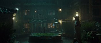 Movie still from “Suburra” (2015), directed by Stefano Sollima – A fountain in the middle of a courtyard in the rain; Extreme Wide shot, Low angle