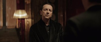 Movie still from “Suburra” (2015), directed by Stefano Sollima – A man in a black jacket is looking at the camera; Close Up shot, Over the shoulder angle