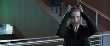 Movie still from “Suburra” (2015), directed by Stefano Sollima – A woman with her hands in her hair; Close Up shot, Over the shoulder angle