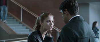 Movie still from “Suburra” (2015), directed by Stefano Sollima – A woman in a leather jacket talking to a man in a suit; Close Up shot, Over the shoulder angle