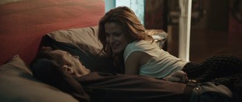 Movie still from “Suburra” (2015), directed by Stefano Sollima – A woman laying in a bed with a man; Medium shot, Over the shoulder angle