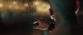 Movie still from “Suburra” (2015), directed by Stefano Sollima – A person's hand reaching out of a window; Extreme Close Up shot, Low angle