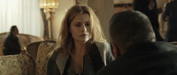 Movie still from “Suburra” (2015), directed by Stefano Sollima – A woman is sitting in front of a man; Close Up shot, Over the shoulder angle