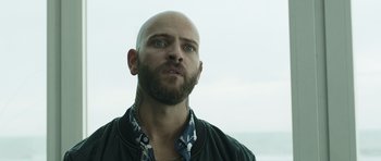 Movie still from “Suburra” (2015), directed by Stefano Sollima – A man with a bald head looking up at the sky; Close Up shot, Low angle