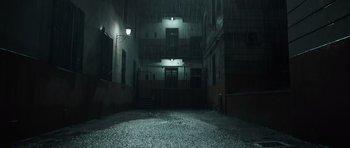 Movie still from “Suburra” (2015), directed by Stefano Sollima – An empty room in a building at night with lights on; Extreme Wide shot, Low angle