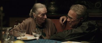 Movie still from “Suburra” (2015), directed by Stefano Sollima – Two people sitting at a table talking to each other; Close Up shot, Over the shoulder angle