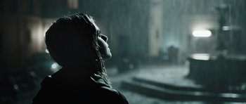 Movie still from “Suburra” (2015), directed by Stefano Sollima – A woman is standing in the pouring rain; Close Up shot, Over the shoulder angle