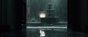Movie still from “Suburra” (2015), directed by Stefano Sollima – A fountain in the middle of the night in the rain; Wide shot, Low angle