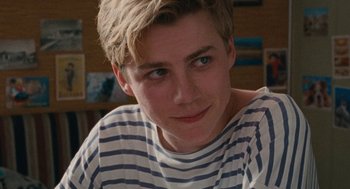 Movie still from “Summer of 85” (2020), directed by François Ozon – A person wearing a striped t - shirt; Close Up shot, Over the shoulder angle