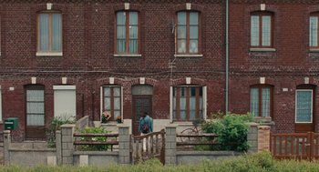 Movie still from “Summer of 85” (2020), directed by François Ozon – A person standing in front of a brick building; Extreme Wide shot, High angle