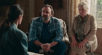 Movie still from “Summer of 85” (2020), directed by François Ozon – A group of people sitting in a living room together; Medium shot, Over the shoulder angle