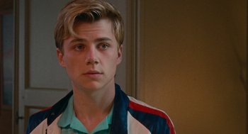 Movie still from “Summer of 85” (2020), directed by François Ozon – A young man with blonde hair wearing a blue shirt; Close Up shot, Over the shoulder angle