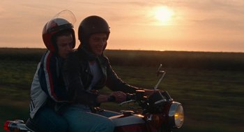 Movie still from “Summer of 85” (2020), directed by François Ozon – Two people on a motorcycle at sunset; Medium shot, Low angle