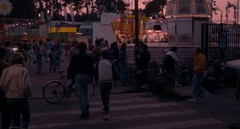 Movie still from “Summer of 85” (2020), directed by François Ozon – A group of people walking down a street at night; Extreme Wide shot, High angle