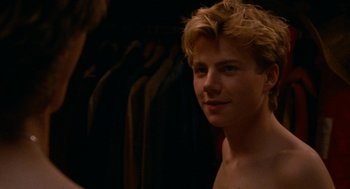 Movie still from “Summer of 85” (2020), directed by François Ozon – A young man with blonde hair is posing for a picture; Close Up shot, Over the shoulder angle