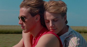 Movie still from “Summer of 85” (2020), directed by François Ozon – A man and a woman embracing each other outside; Close Up shot, High angle