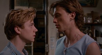 Movie still from “Summer of 85” (2020), directed by François Ozon – Two young men face each other in a room; Close Up shot, Over the shoulder angle