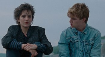 Movie still from “Summer of 85” (2020), directed by François Ozon – A woman and a man sitting next to each other; Medium shot, Over the shoulder angle