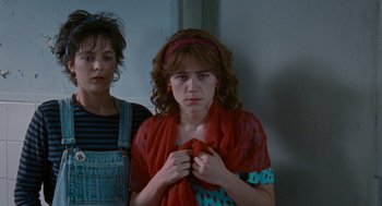 Movie still from “Summer of 85” (2020), directed by François Ozon – Two women standing next to each other in front of a wall; Medium shot, Over the shoulder angle