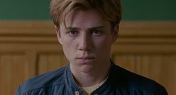 Movie still from “Summer of 85” (2020), directed by François Ozon – A person wearing a blue shirt; Close Up shot, High angle