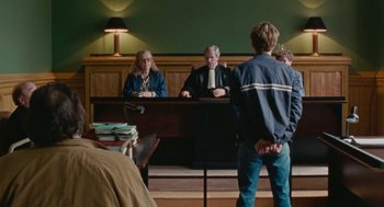 Movie still from “Summer of 85” (2020), directed by François Ozon – A man standing in front of two other people; Wide shot, Over the shoulder angle