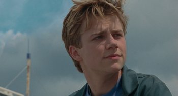 Movie still from “Summer of 85” (2020), directed by François Ozon – A young man is looking into the distance; Close Up shot, Low angle